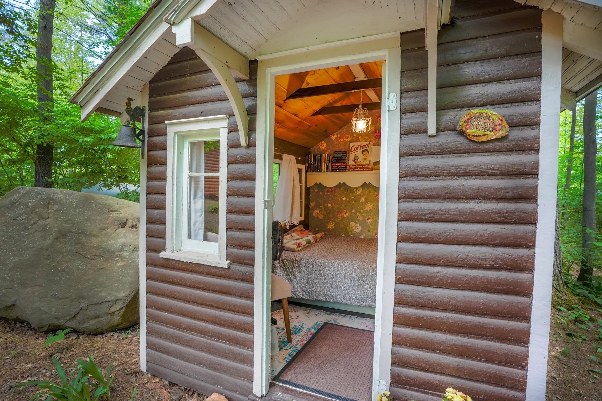 A cabin with a bed and a window in it