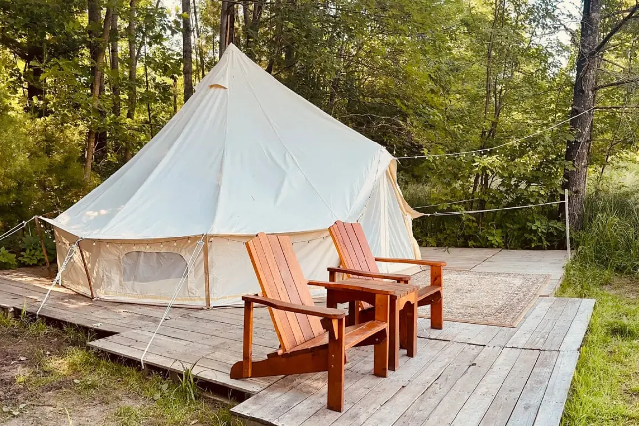 A tent with two chairs on the ground