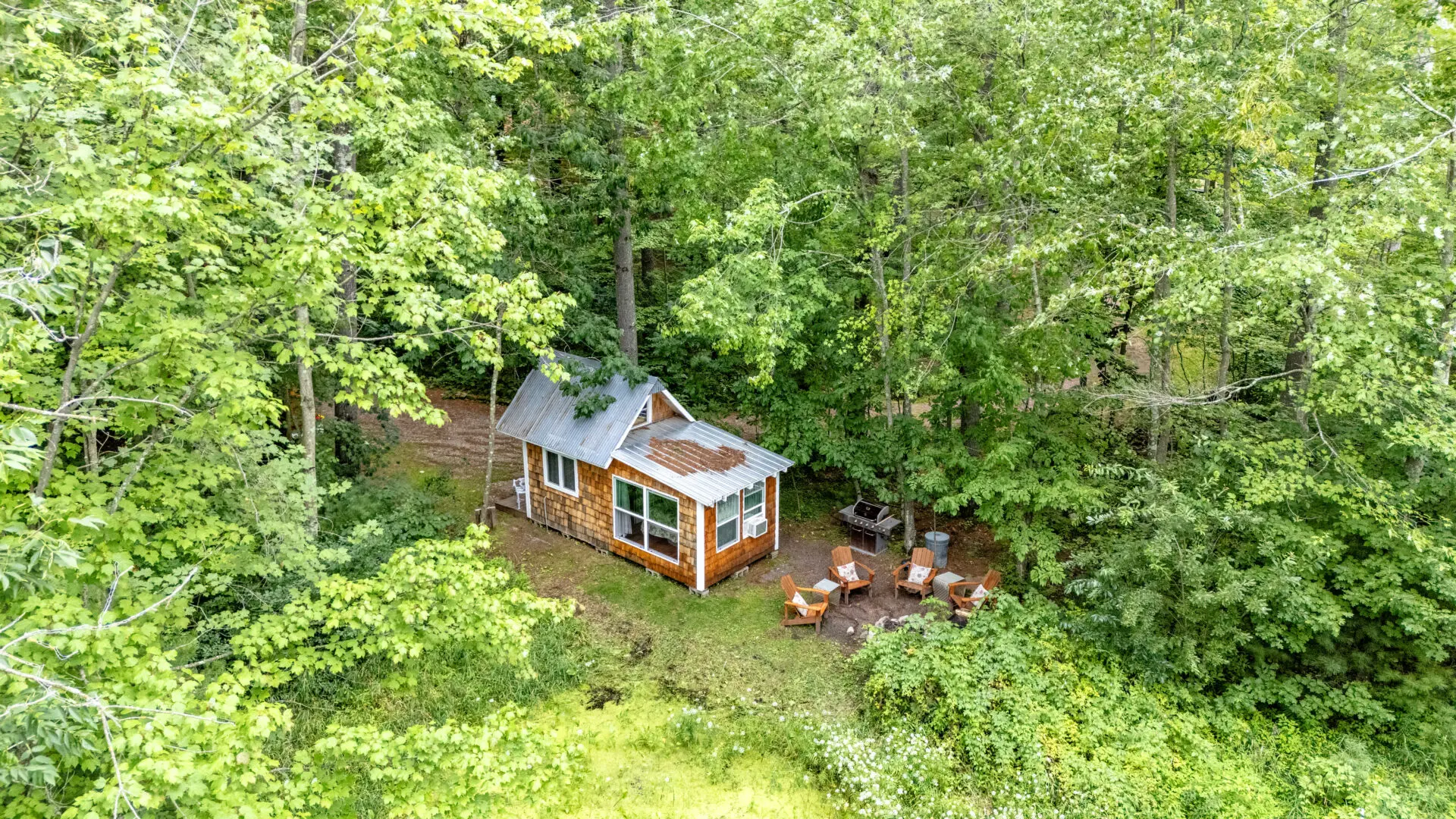 A small cabin in the middle of a forest.