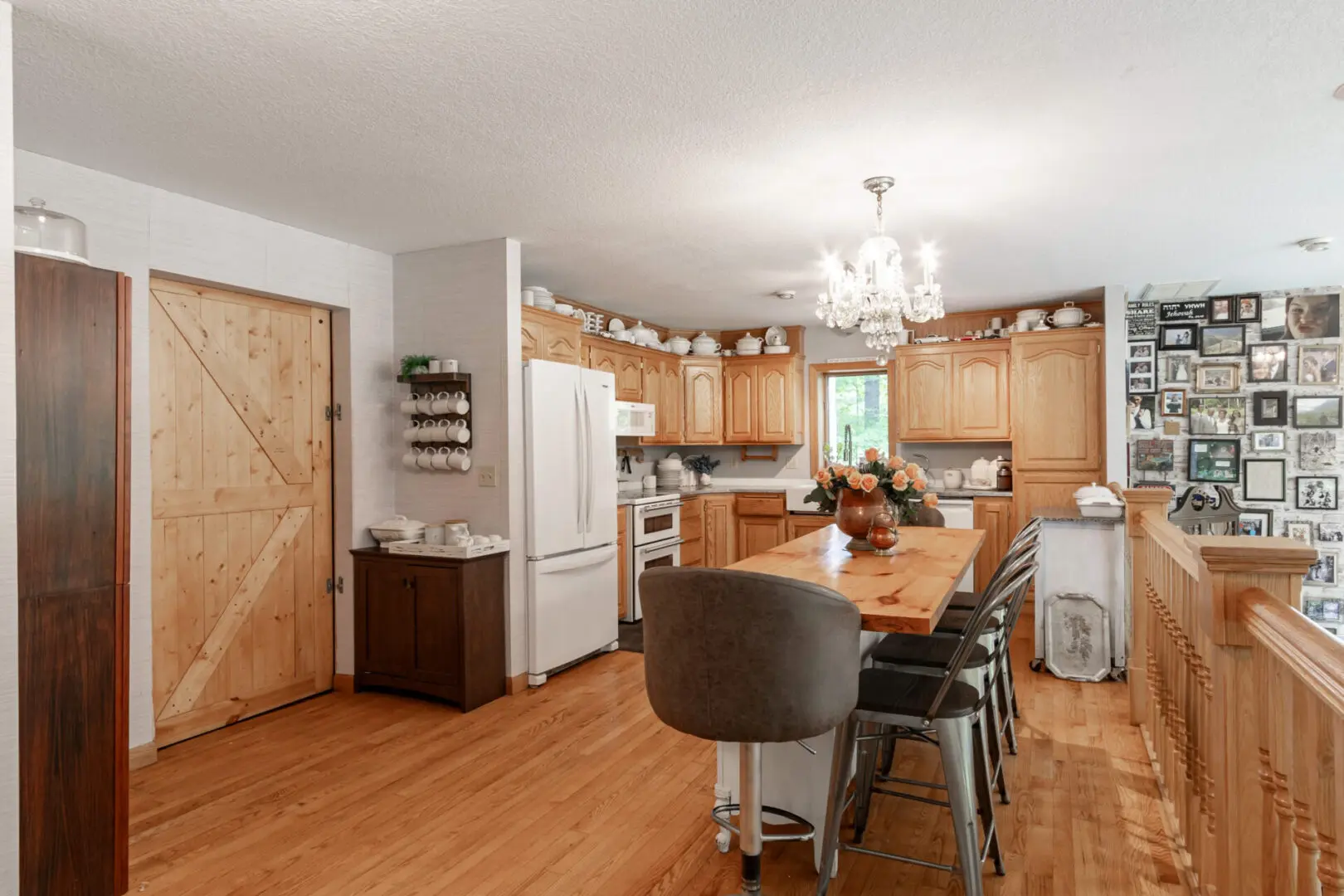 A kitchen with wooden floors and cabinets.