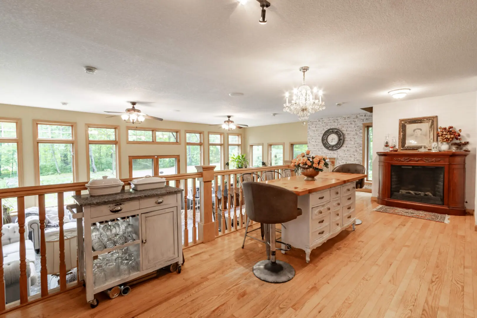 A large kitchen with wooden floors and white cabinets.