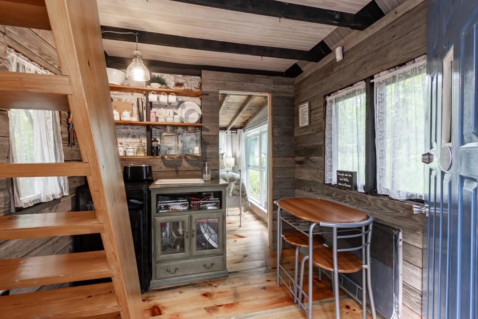 A kitchen with wooden floors and walls.