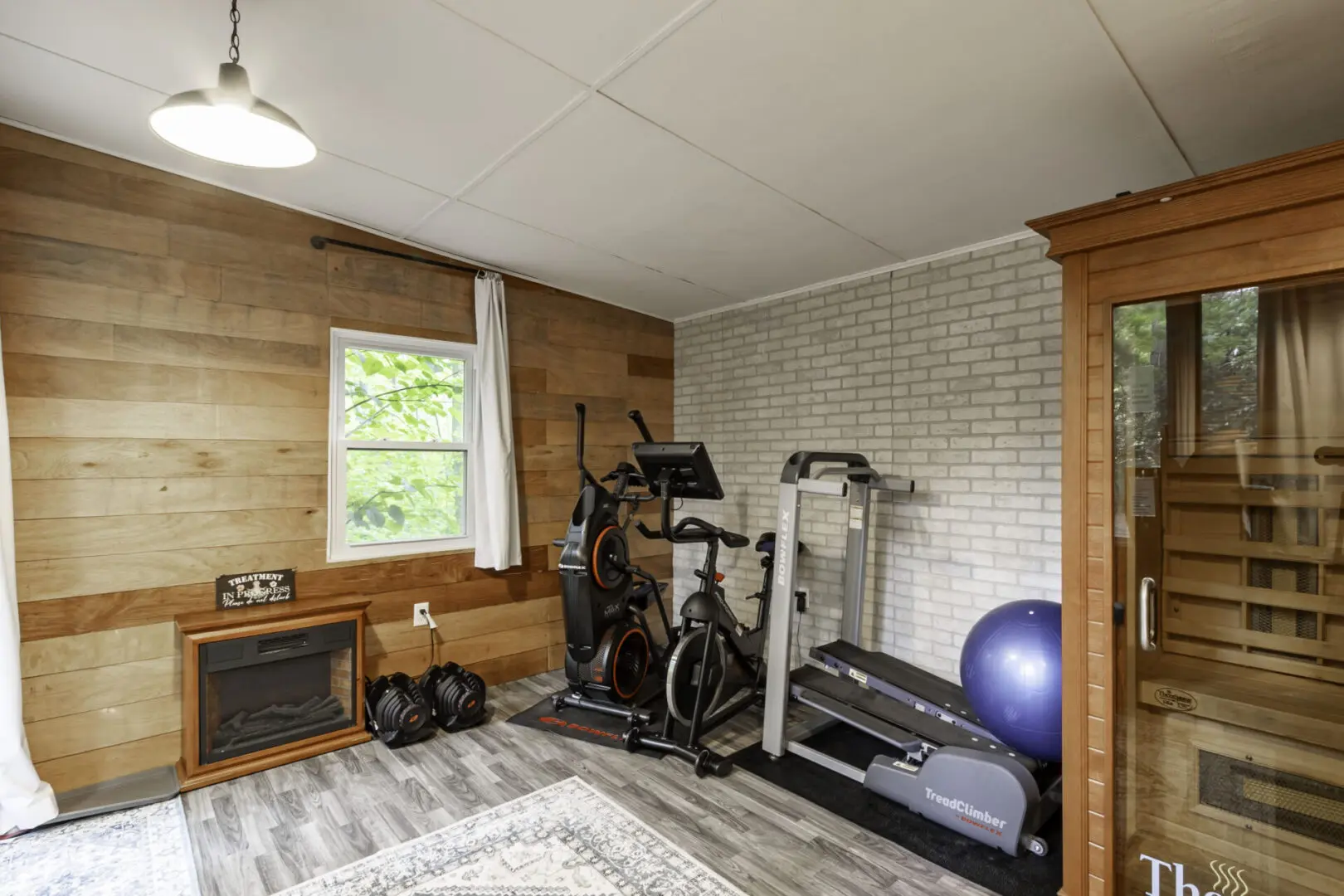 A room with a gym and exercise equipment.