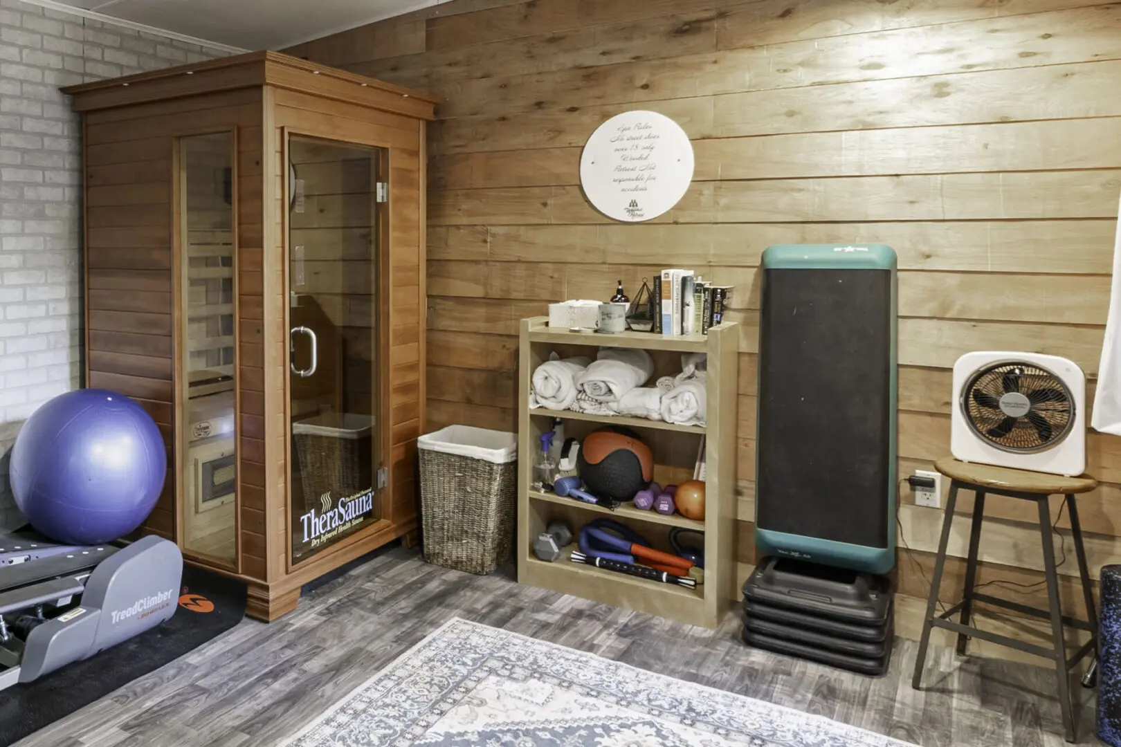 A room with a wooden wall and a small cabinet