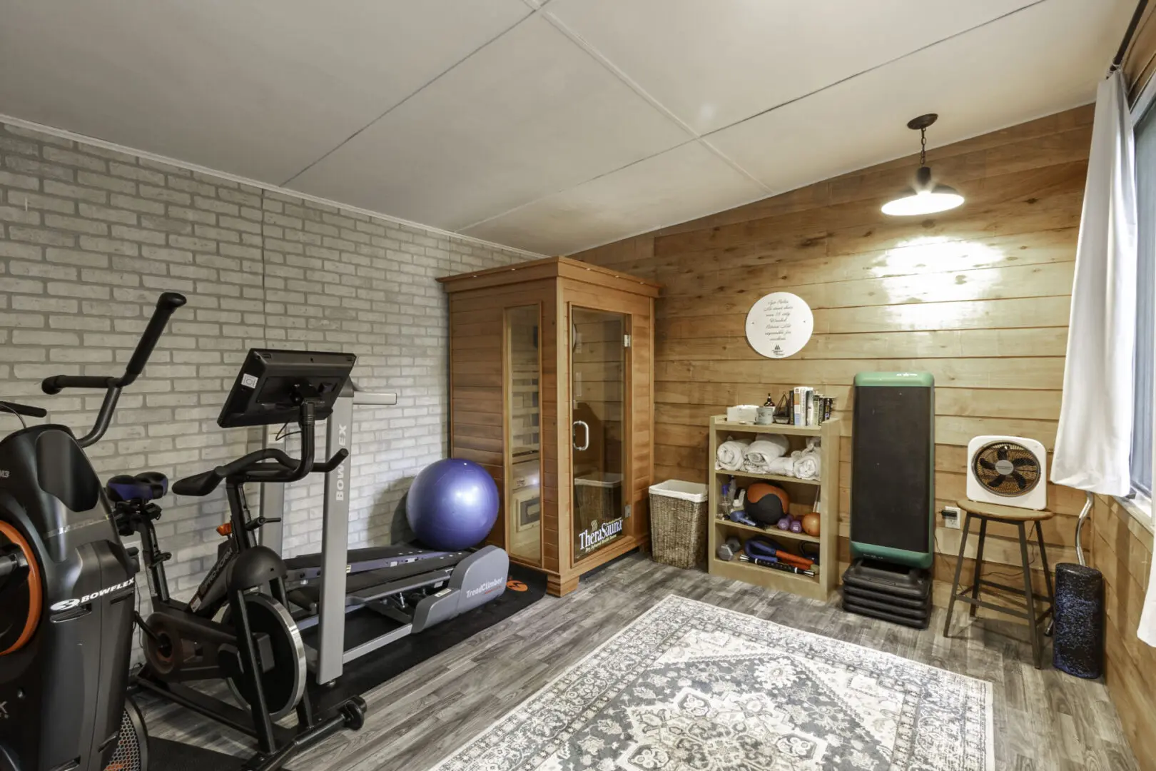 A room with a gym and a yoga ball