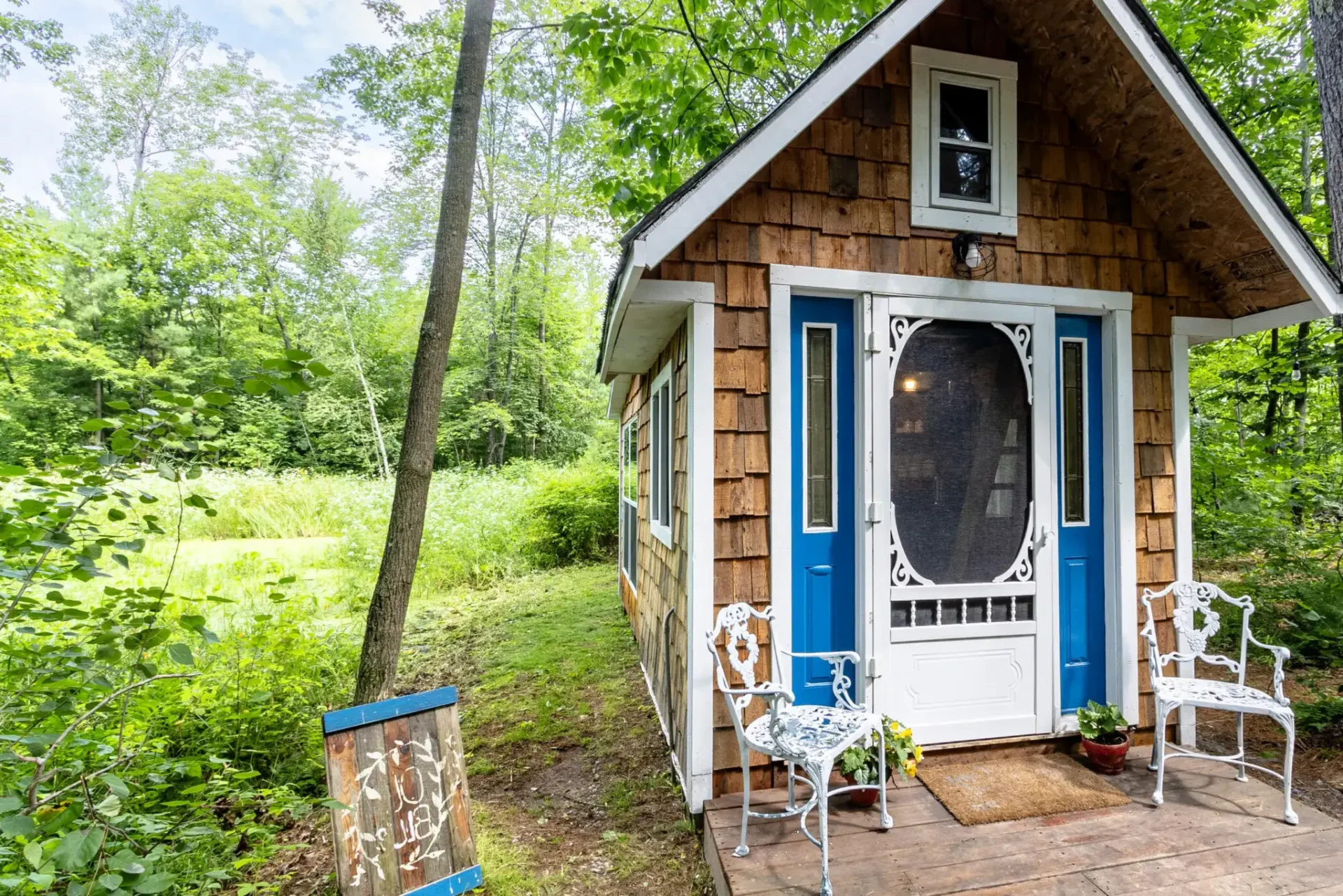 A small house with blue door and white window.