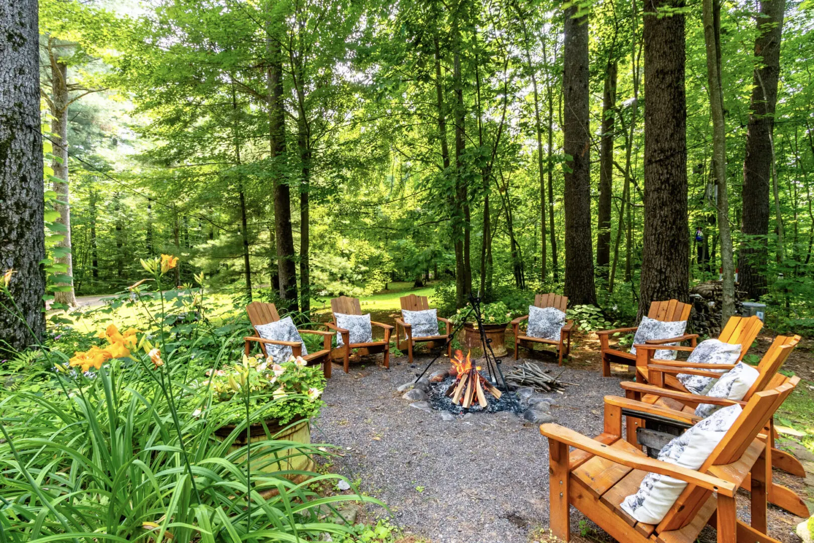 A group of people sitting around a fire pit.